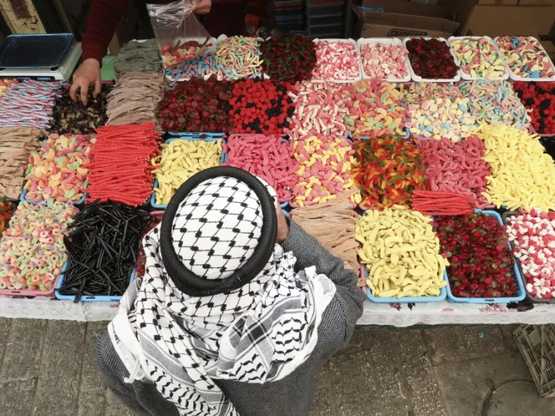 A Palestinian street vendor sells candy and sweets in Hebron's Old City in the Israeli-occupied West Bank 