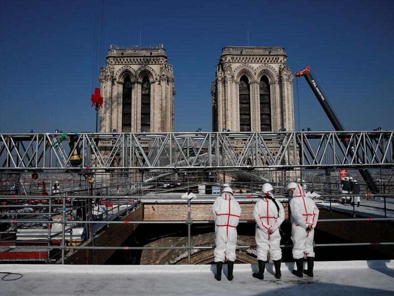 People stand on the roof of the Notre-Dame de Paris Cathedral 