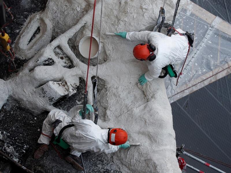Rope access technicians work on a damaged vault of the Notre-Dame de Paris Cathedral 