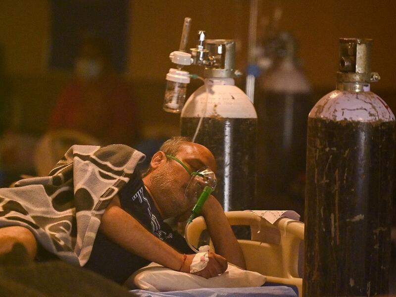 A Covid-19 coronavirus positive patient seen inside a banquet hall temporarily converted into a covid care centre in New Delhi 