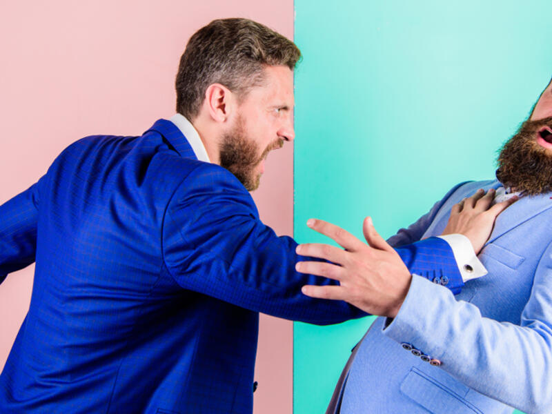 Business partners competitors office colleagues tense faces conflict situation