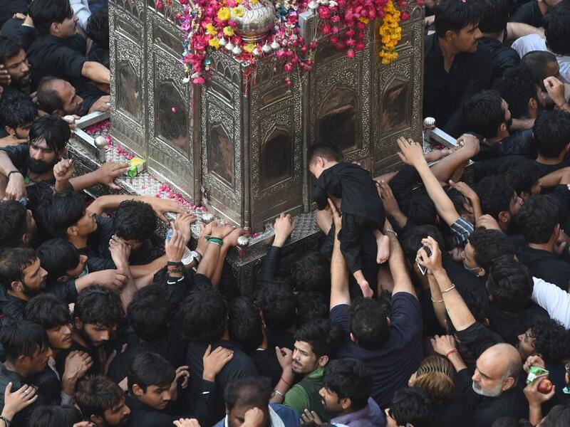 Shiite Muslim devotees take part in a procession to commemorate the death anniversary of Prophet Mohammad's companion 