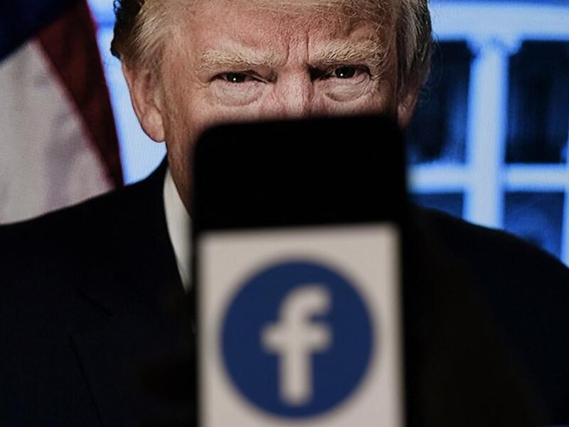  In this file photo illustration, a phone screen displays a Facebook logo 