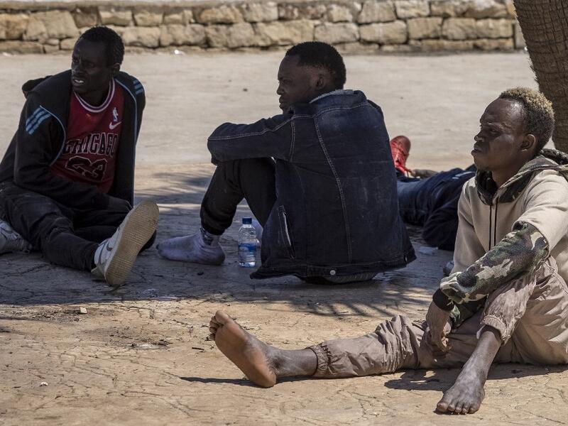 Subsaharian migants wait near the sea in the northern town of Fnideq as they attempt to cross the border from Morocco to Spain's North African enclave of Ceuta on May 19, 2021. Spain stepped up diplomatic pressure on Rabat as its prime minister flew into Ceuta, vowing to "restore order" in the North African enclave after a record 8,000 migrants reached its beaches from Morocco