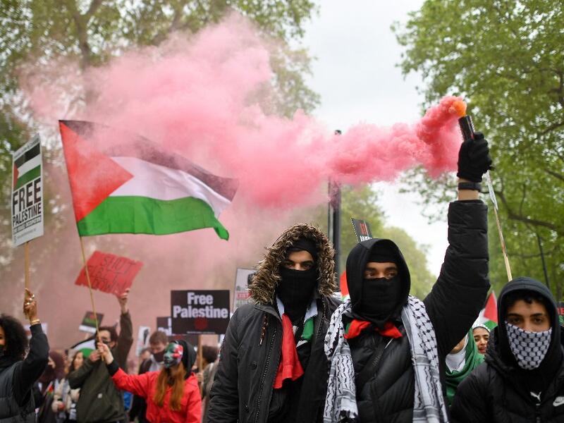 Pro-Palestine protesters set Israeli flags on fire outside the London embassy