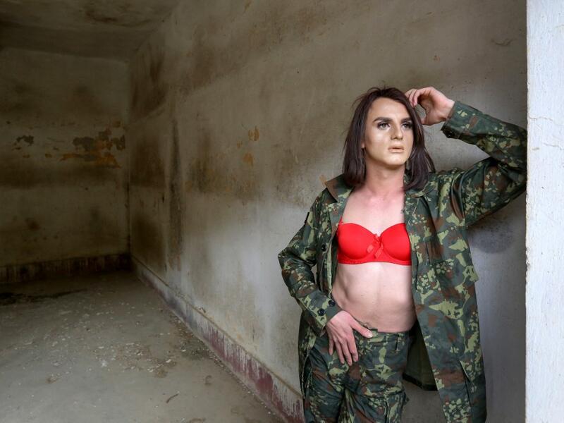 Albanian transgender Luana, poses in military dress during a photo shooting session, in the former Communist-era maximum security prison for political prisoners in Spac