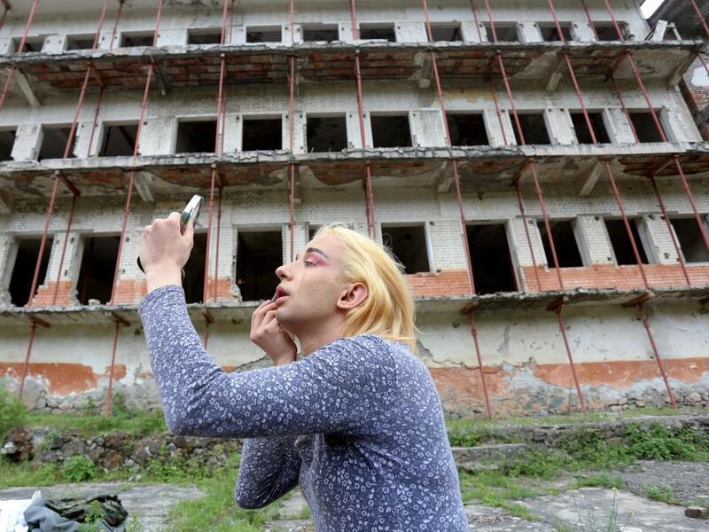 Albanian transgender Lola, puts her makeup on, in the former Communist-era maximum security prison for political prisoners in Spac