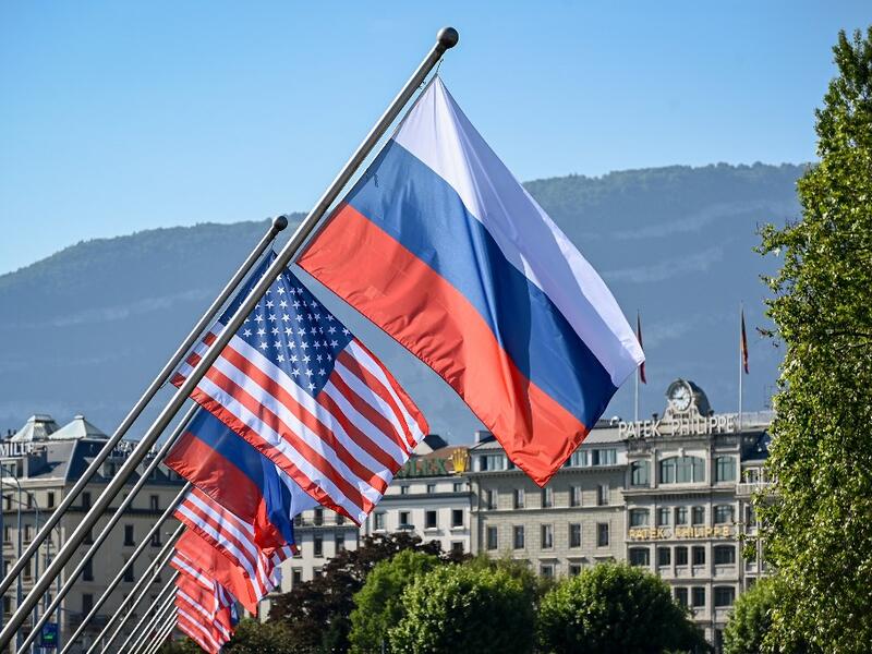 Russians and US flags are seen on the Mont-Blanc bridge on June 16, 2021 in Geneva ahead of the summit between Russian leader and US President