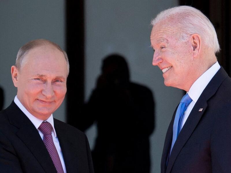 Russian President Vladimir Putin (L) shakes hands with US President Joe Biden prior to the US-Russia summit at the Villa La Grange, in Geneva 