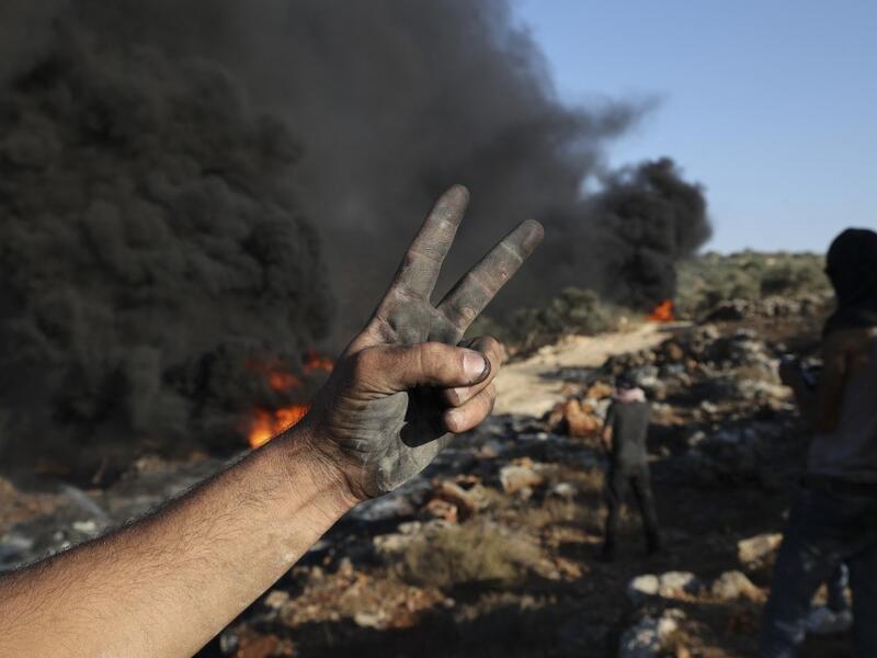 Palestinians burn tires during demonstrations against the expansion of the Jewish settlement outpost of Eviatar, on the lands of Beita village, near the occupied West Bank city of Nablus