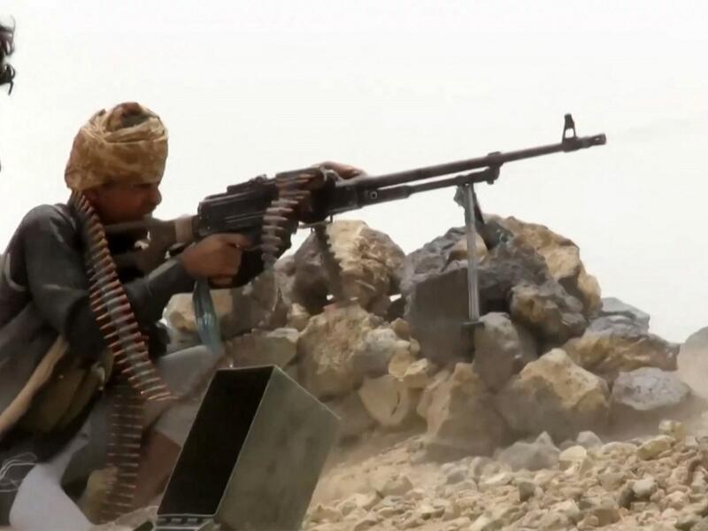 A grab from an AFPTV video shows a fighter loyal to Yemen's Saudi-backed government manning a machine gun at a position near the frontlines against the Huthi rebel forces in the region of al-Kassara,