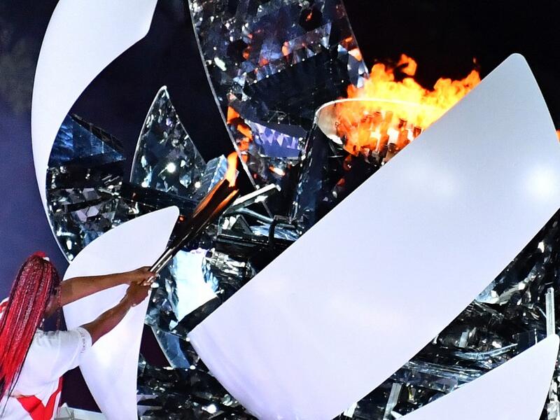 An overview shows Japan's tennis player Naomi Osaka lighting the flame of hope in the Olympic Cauldron during the opening ceremony of the Tokyo 2020 Olympic Games, at the Olympic Stadium, in Tokyo