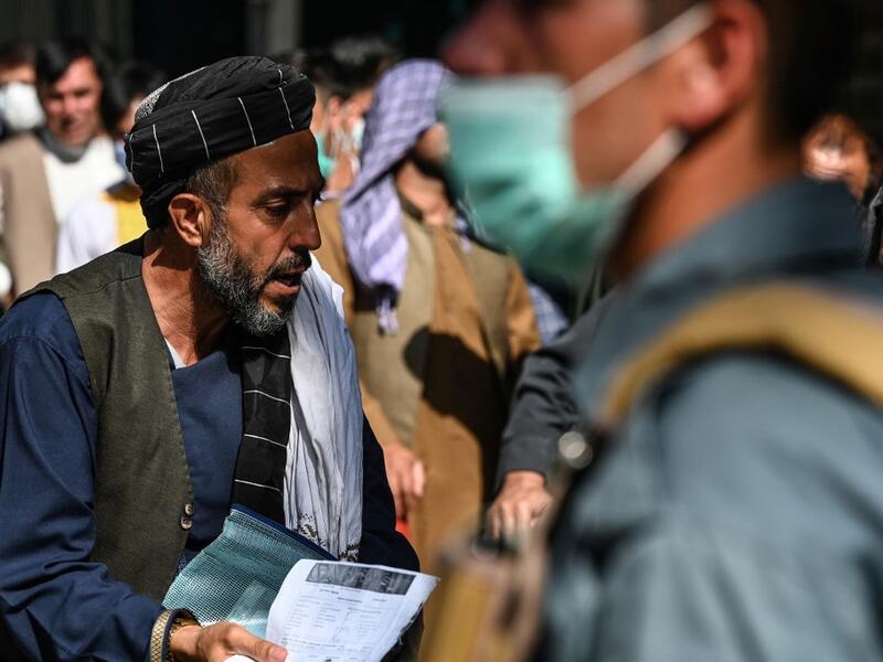 A man arrives to submit his passport application at an office in Kabul on July 25, 2021. Dozens begin lining up at the passport office in Kabul before dawn most days, and by eight in the morning the queue already stretches for a good hundred metres.