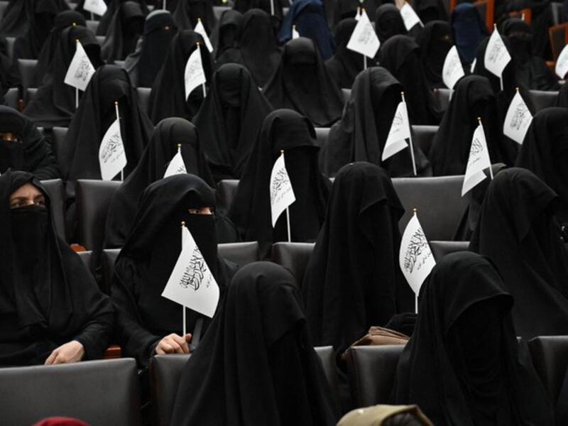 Afghan women wearing full face veils, pledging commitment to Taliban's policies on gender segregation (AFP)