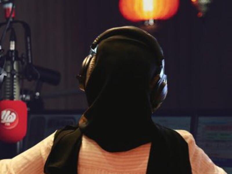 With her back to the microphone 