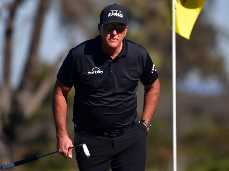 Phil Mickelson lines up his putt on the 10th hole green during the second round of The Farmers Insurance Open on the North Course at Torrey Pines Golf Course on January 27, 2022 in La Jolla, California. Donald Miralle/Getty Images/AFP (Photo by DONALD MIRALLE / GETTY IMAGES NORTH AMERICA / Getty Images via AFP)
