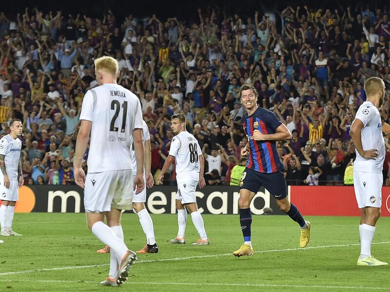 Barcelona's Polish forward Robert Lewandowski (2nd-L) celebrates after scoring his team's third goal during the UEFA Champions League Group C first-leg football match between FC Barcelona and Viktoria Plzen, at the Camp Nou stadium in Barcelona on September 7, 2022. (Photo by Pau BARRENA / AFP)