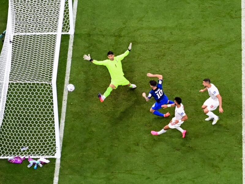USA's forward #10 Christian Pulisic scores his team's first goal past Iran's goalkeeper #01 Alireza Beiranvand during the Qatar 2022 World Cup Group B football match between Iran and USA at the Al-Thumama Stadium in Doha on November 29, 2022. (Photo by Odd ANDERSEN / AFP)