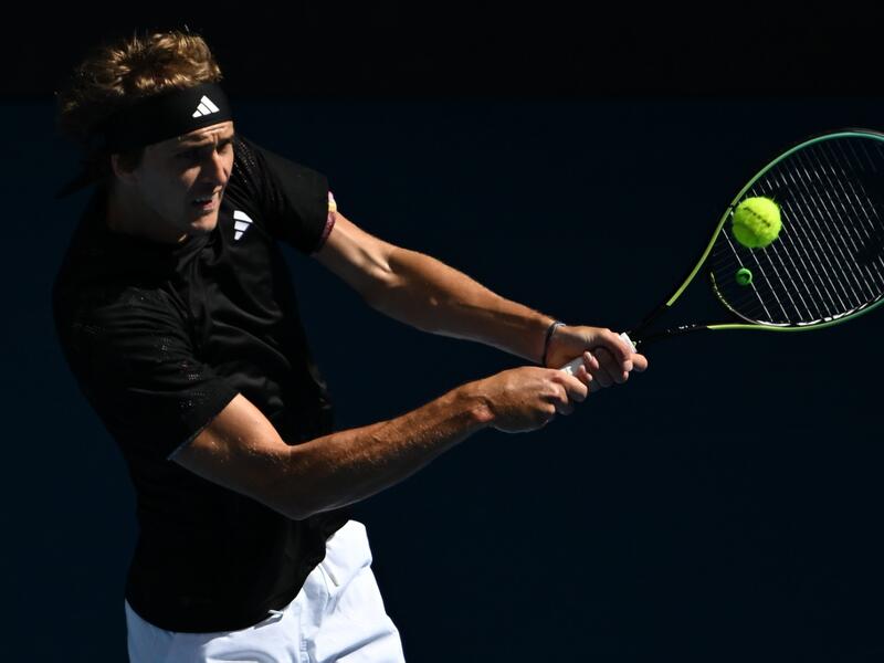 Germany's Alexander Zverev hits a return against Michael Mmoh of the US during their men's singles match on day four of the Australian Open tennis tournament in Melbourne on January 19, 2023. (Photo by Manan VATSYAYANA / AFP)