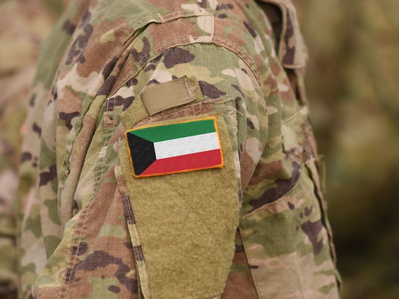 Kuwait flag on soldiers arm (collage)