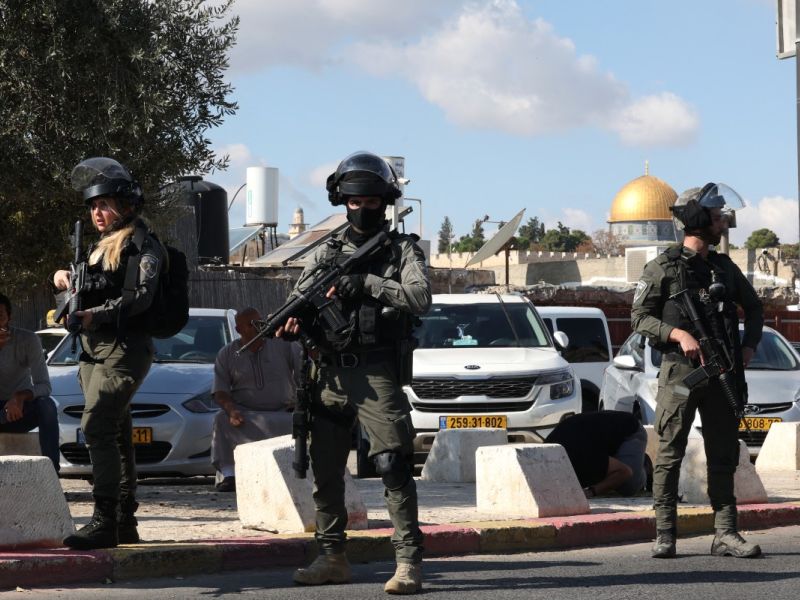 Israeli occupation forces stand guard as Palestinians take part in Friday
