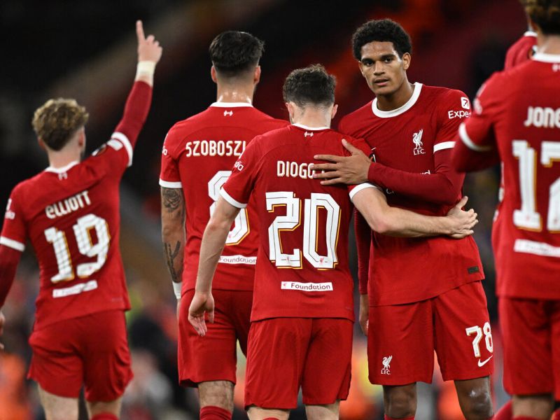 Liverpool's Portuguese striker #20 Diogo Jota (C) celebrates with teammates after scoring their second goal during the UEFA Europa League group E football match between Liverpool and Royale Union Saint-Gilloise at Anfield in Liverpool, north west England on October 5, 2023. Liverpool won the game 2-0. (Photo by Oli SCARFF / AFP)