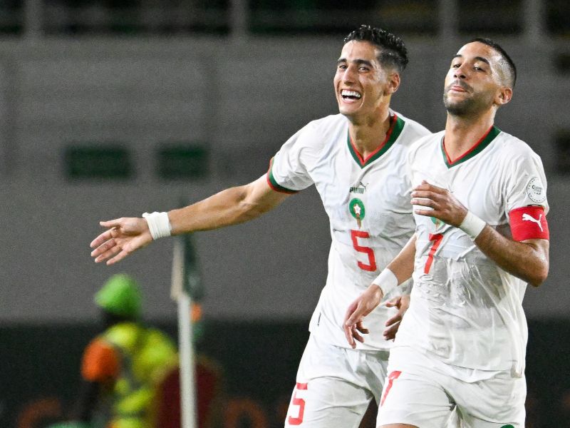 orocco's midfielder #7 Hakim Ziyech (R) celebrates with Morocco's defender #5 Nayef Aguerd after scoring his team's first goal during the Africa Cup of Nations (CAN) 2024 group F football match between Zambia and Morocco at the Stade Laurent Pokou in San Pedro on January 24, 2024. (Photo by SIA KAMBOU / AFP)