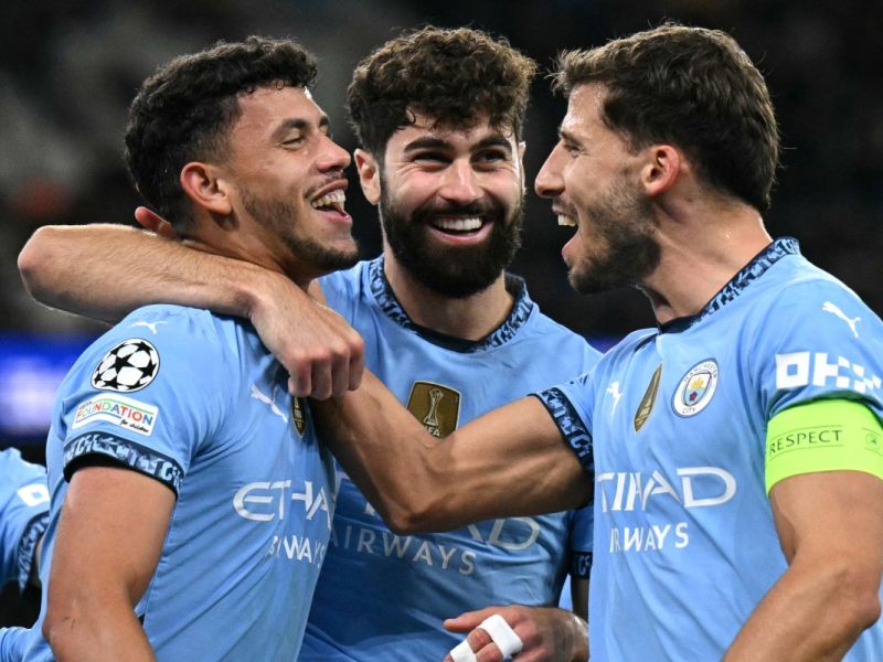 Manchester City's Portuguese midfielder #27 Matheus Nunes (L) celebrates scoring the team's fifth goal with Manchester City's Croatian defender #24 Josko Gvardiol (C) and Manchester City's Portuguese defender #03 Ruben Dias during the UEFA Champions League football match between Manchester City and Sparta Prague at the Etihad Stadium in Manchester, north west England, on October 23, 2024.h west England, on October 23, 2024. (Photo by Oli SCARFF / AFP)