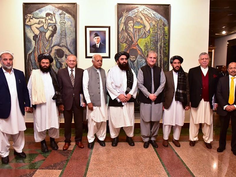 This handout photograph taken and released by Pakistan's Ministry of Foreign Affairs on November 11, 2021, shows Afghanistan's acting Foreign Minister Amir Khan Muttaqi (C), Pakistan's Foreign Minister Shah Mahmood Qureshi (4R), Pakistan Minister for Aviation Ghulam Sarwar Khan (4L), Pakistan's Prime Minister commerce adviser Abdul Razak Dawood (3L) pose for picture along with other delegation members at Pakistan's Foreign Ministry, in Islamabad. AFP Afghanistan, Pakistan extend ceasefire in Istanbul talks