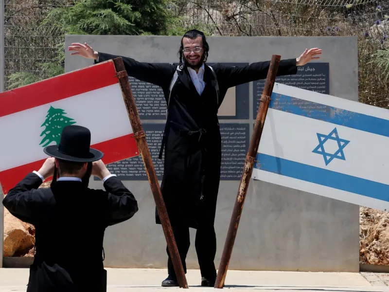 Jew standing on monument on the Lebanese-Israeli border