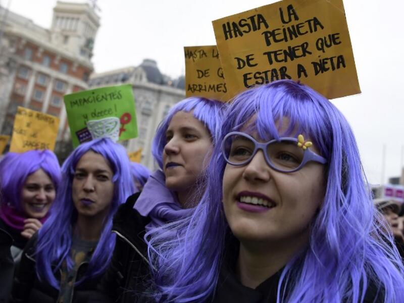 Woman sporting wigs attend a demonstration to defend women's rights on International Women's Day in Madrid, on Mar. 8, 2018. Spain celebrated International Women's Day today with an unprecedented general strike in defense of their rights that saw hundreds of trains cancelled and countless protests scheduled throughout the day.
(OSCAR DEL POZO / AFP)