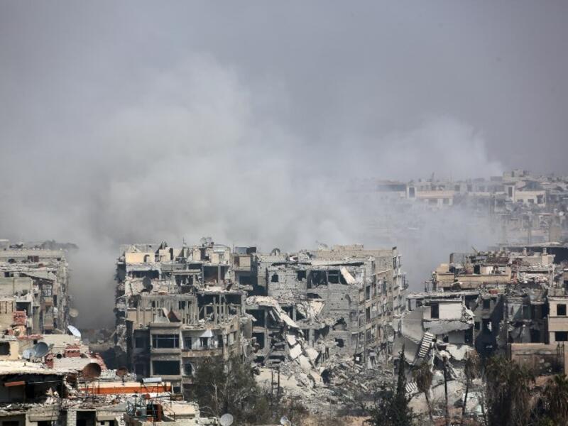 Smoke billows following Syrian government bombardment on the rebel-held besieged town of Harasta, in the Eastern Ghouta region on the outskirts of Damascus on Mar. 12, 2018. (AFP)