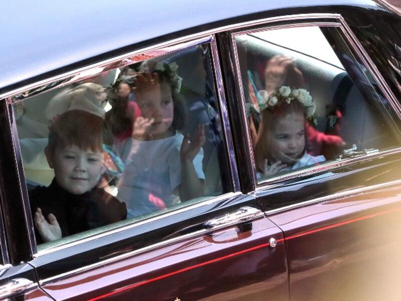 Prince Harry's niece and bridesmaid Princess Charlotte (R) arrives for the wedding ceremony of Britain's Prince Harry, Duke of Sussex and US actress Meghan Markle at St George's Chapel, Windsor Castle, in Windsor, on May 19, 2018. 
Andrew Matthew/ AFP