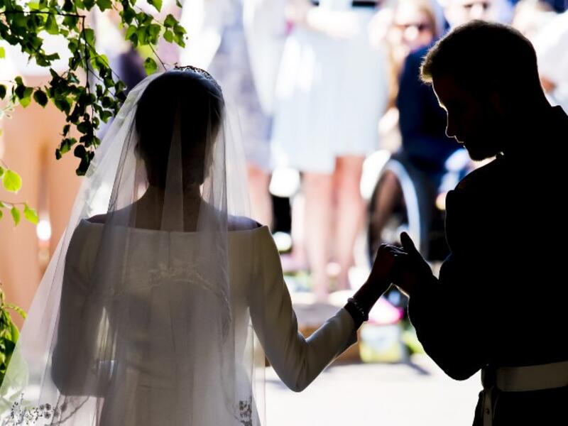 Britain's Prince Harry, Duke of Sussex and his wife Meghan, Duchess of Sussex emerge from the West Door of St George's Chapel, Windsor Castle, in Windsor, on May 19, 2018 after their wedding ceremony. 
Danny Lawson/ AFP