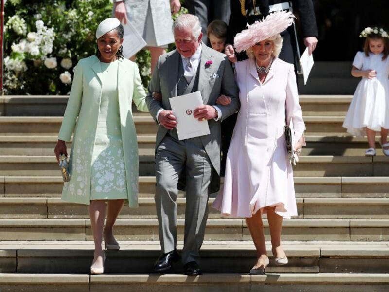 (L-R) Meghan Markle's mother Doria Ragland, Britain's Prince Charles, Prince of Wales (C) and Britain's Camilla, Duchess of Cornwall leave after the wedding ceremony of Britain's Prince Harry, Duke of Sussex and US actress Meghan Markle at St George's Chapel, Windsor Castle, in Windsor, on May 19, 2018. 
Jane Barlow/ AFP