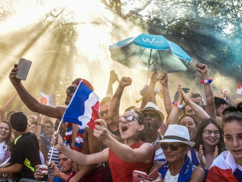 People celebrate France's victory in the Russia 2018 World Cup final football match between France and Croatia, on July 15, 2018 in Nantes city center. 
SEBASTIEN SALOM GOMIS / AFP