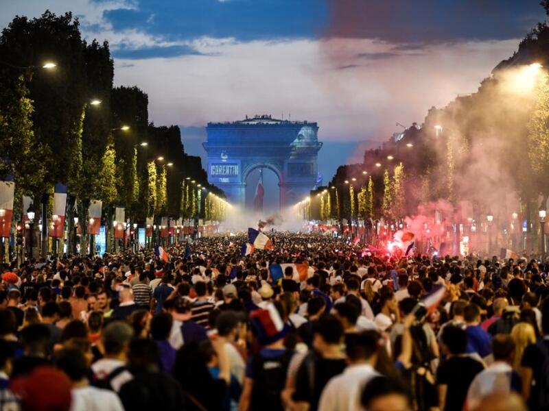 People celebrate France's victory in the Russia 2018 World Cup final football match between France and Croatia, on the Champs-Elysees avenue in Paris on July 15, 2018. 
Eric FEFERBERG / AFP