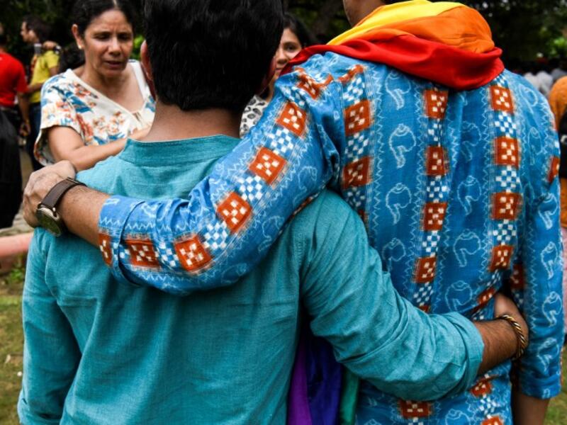 Indian members of the lesbian, gay, bisexual, transgender (LGBT) community pose for a picture outside the Supreme Court after the decision to strike down the colonial-era ban on gay sex in New Delhi on September 6, 2018. 
CHANDAN KHANNA / AFP