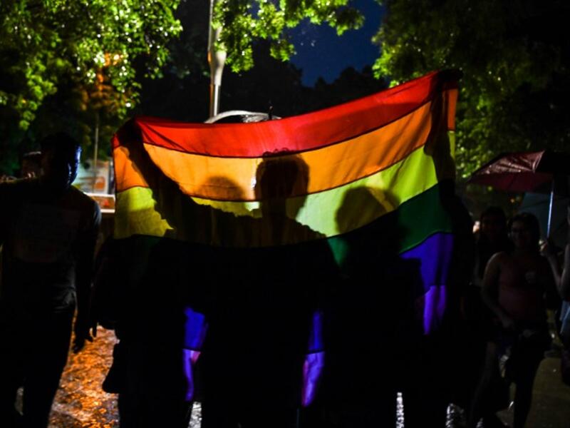 Indian members and supporters of the lesbian, gay, bisexual, transgender (LGBT) community celebrate the Supreme Court decision to strike down a colonial-era ban on gay sex, during heavy rainfall in New Delhi on September 6, 2018. 
CHANDAN KHANNA / AFP