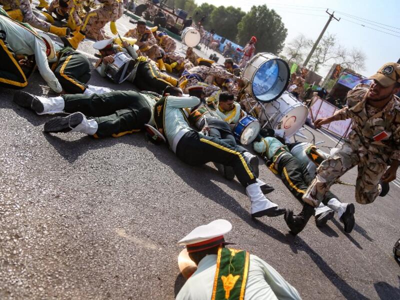 Iranians scramble to the ground during the attack in Ahvaz, Iran (MORTEZA JABERIAN /AFP)
