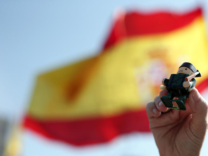 A person holds up a toy figurine depicting a civil guard during a demonstration in support of Spanish police in Barcelona on September 29, 2018. 
Pau Barrena / AFP