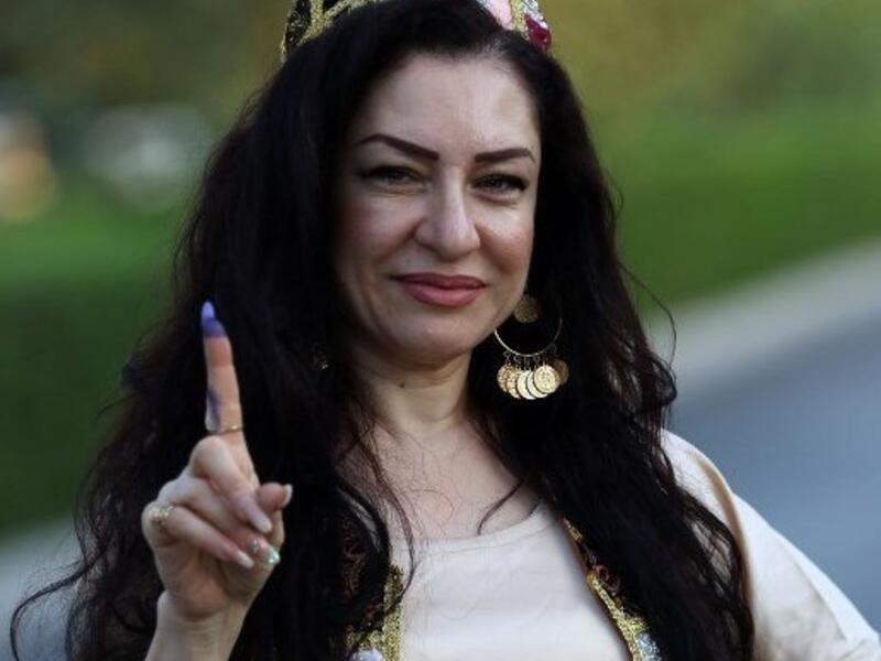 An Iraqi Kurdish woman shows her ink-stained index finger after casting her ballot for the parliamentary election at a polling station in Arbil, the capital of the Kurdish autonomous region in northern Iraq, on September 30, 2018. 
SAFIN HAMED / AFP