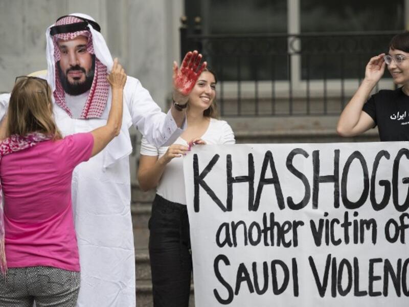 A demonstrator dressed as Saudi Arabian Crown Prince Mohammed bin Salman (C) with blood on his hands protests with others outside the Saudi Embassy in Washington, DC. (Jim WATSON / AFP)