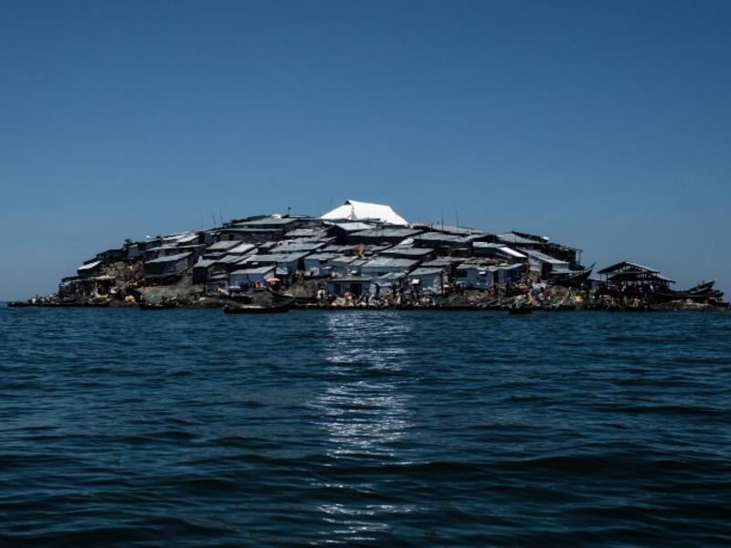 A picture taken on October 5, 2018, shows a newly-built tin roof shining on top of Migingo island which is densely populated by residents fishing mainly for Nile perch in Lake Victoria on the border of Uganda and Kenya. 
Yasuyoshi CHIBA / AFP