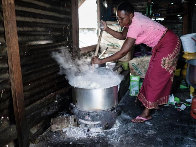 A woman prepares Ugali, a typical local food made of maize flour, on Migingo island on October 5, 2018 which is densely populated by residents fishing mainly for Nile perch in Lake Victoria on the border of Uganda and Kenya. 
Yasuyoshi CHIBA / AFP