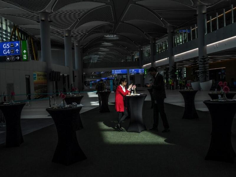 Visitors are seen taking a break in the new airport building during a press tour of Istanbul's third airport, the Istanbul New Airport, in the Arnavutkoy district on the European side of Istanbul on October 25, 2018. 
BULENT KILIC / AFP