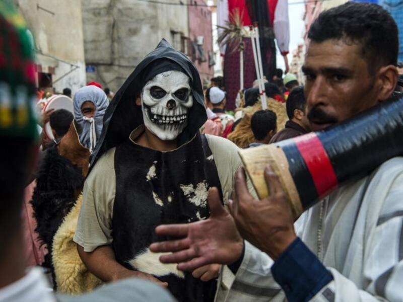 Young Moroccans take part in the Boujloud festival, a popular festival also known as the 'Moroccan Halloween' in the Sidi Moussa district of Sale near Rabat, on October 27, 2018. 
FADEL SENNA / AFP