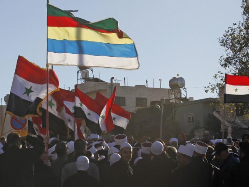 Druze men protest against municipal elections in front of a polling centre in the village of Majdal Shams in the Israeli-annexed Golan Heights on October 30, 2018. (JALAA MAREY / AFP)