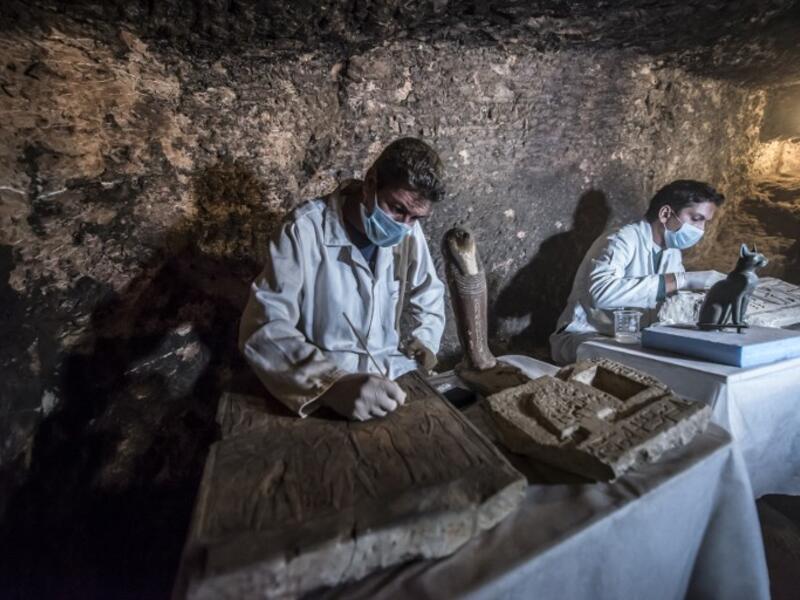 Egyptian archaeologists work on monuments after being discovered on the stony edge of King Userkaf pyramid complex in Saqqara Necropolis, south of the capital Cairo. (KHALED DESOUKI / AFP)