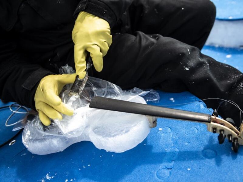 US artist Tim Linhart works on an ice violin in the "Ice Dome" on Presena Galcier, Tonale Pass, near Trento in northern Italy on January 18, 2018. 
MARCO BERTORELLO / AFP